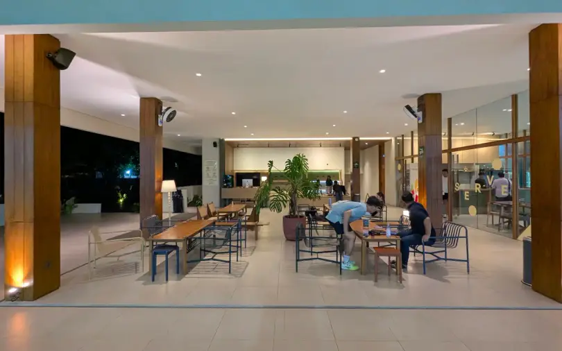 The open clubhouse lounge between teak columns