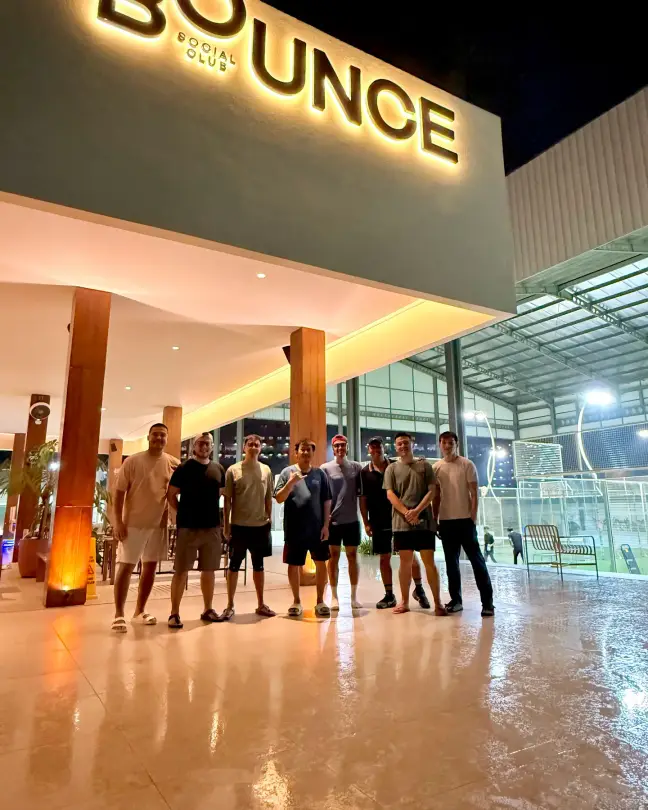 A group under the illuminated Bounce sign